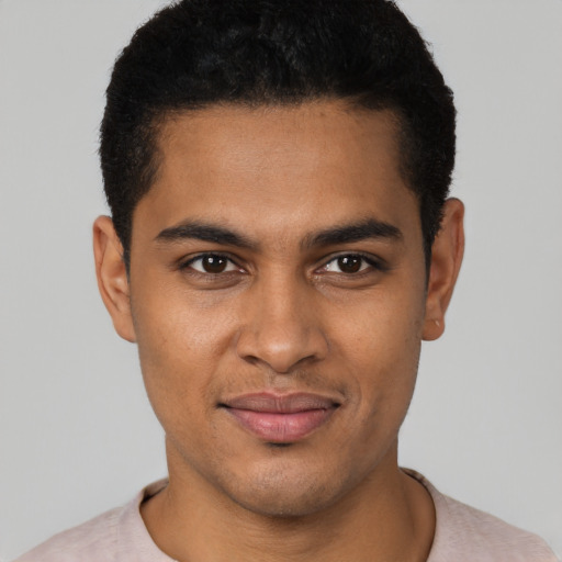 Joyful latino young-adult male with short  black hair and brown eyes