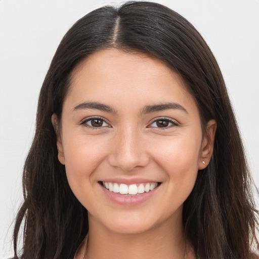 Joyful white young-adult female with long  brown hair and brown eyes