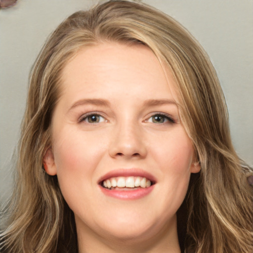 Joyful white young-adult female with long  brown hair and blue eyes