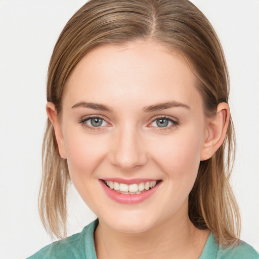 Joyful white young-adult female with medium  brown hair and blue eyes