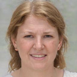 Joyful white adult female with medium  brown hair and grey eyes