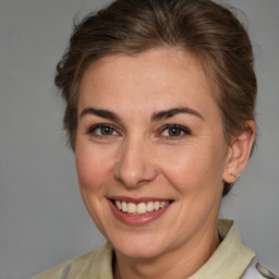 Joyful white adult female with medium  brown hair and brown eyes