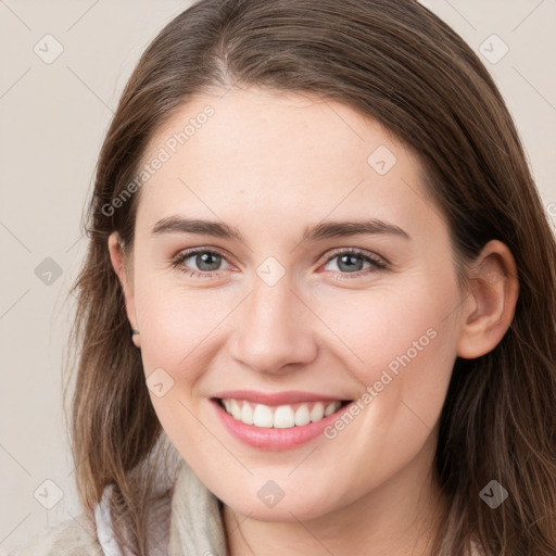 Joyful white young-adult female with long  brown hair and grey eyes