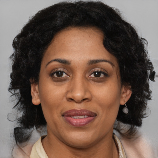 Joyful black adult female with medium  brown hair and brown eyes