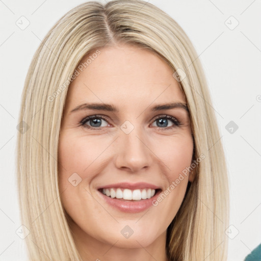 Joyful white young-adult female with long  brown hair and green eyes