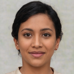 Joyful latino young-adult female with medium  brown hair and brown eyes