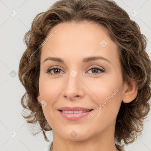 Joyful white young-adult female with medium  brown hair and green eyes