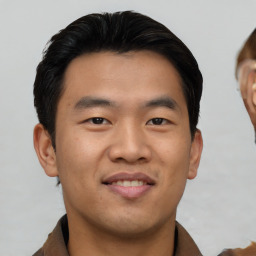 Joyful asian young-adult male with short  brown hair and brown eyes