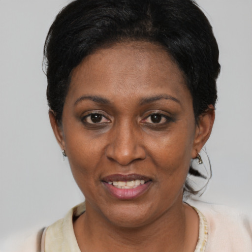 Joyful black adult female with short  black hair and brown eyes