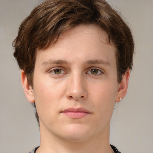 Joyful white young-adult male with short  brown hair and green eyes