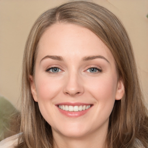 Joyful white young-adult female with long  brown hair and green eyes