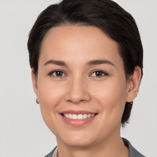 Joyful white young-adult female with short  brown hair and brown eyes