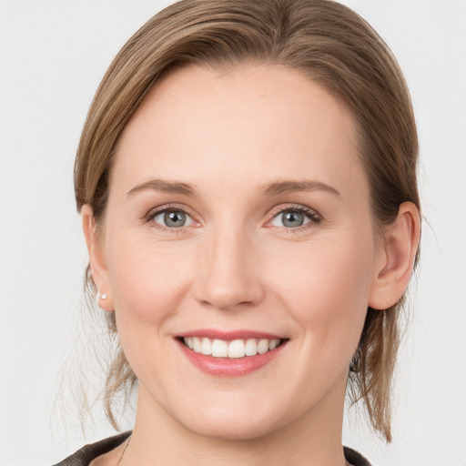 Joyful white young-adult female with medium  brown hair and blue eyes