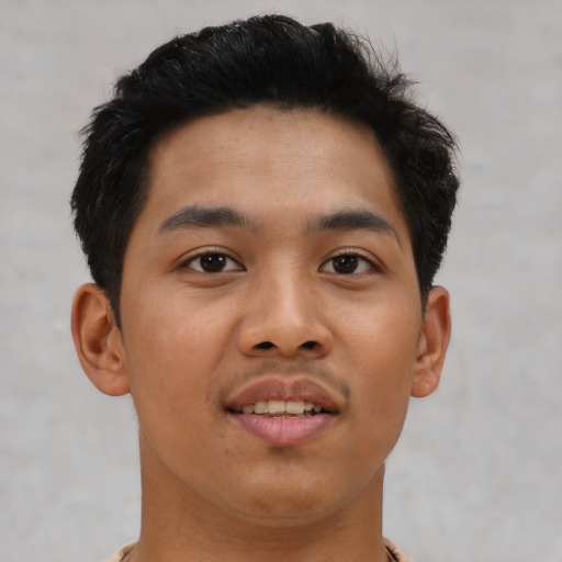 Joyful asian young-adult male with short  brown hair and brown eyes