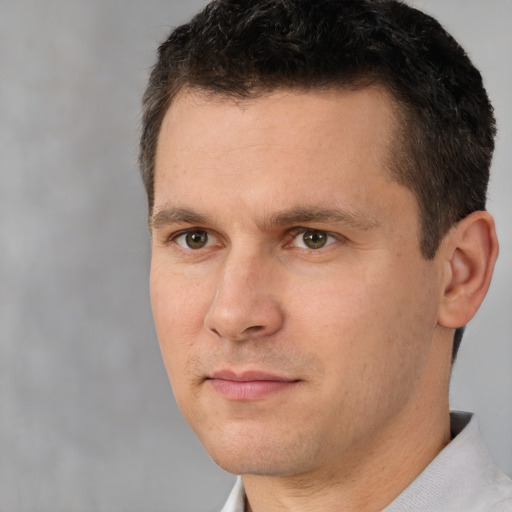 Joyful white adult male with short  brown hair and brown eyes