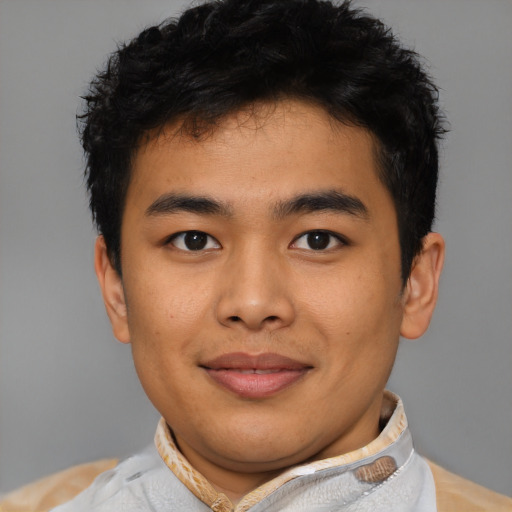 Joyful asian young-adult male with short  black hair and brown eyes