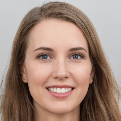 Joyful white young-adult female with long  brown hair and grey eyes