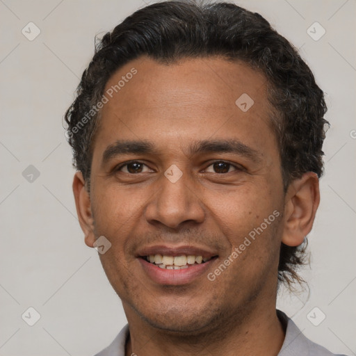 Joyful latino young-adult male with short  brown hair and brown eyes