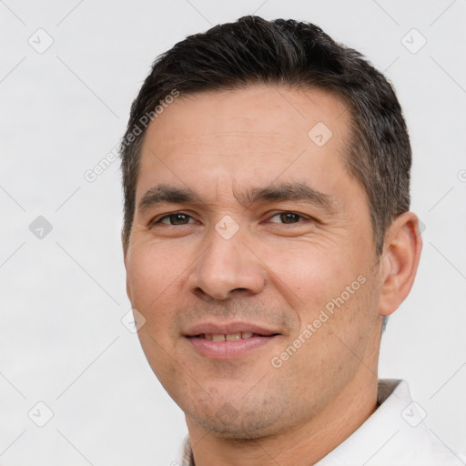 Joyful white adult male with short  brown hair and brown eyes