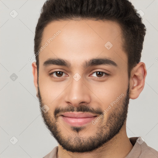 Joyful white young-adult male with short  brown hair and brown eyes