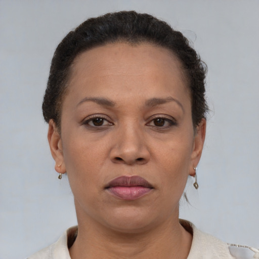 Joyful black adult female with short  brown hair and brown eyes