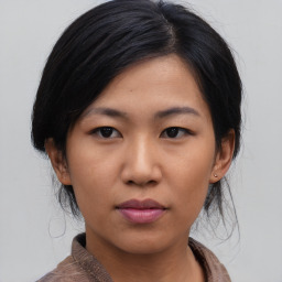 Joyful asian young-adult female with medium  black hair and brown eyes