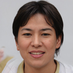 Joyful asian young-adult female with medium  brown hair and brown eyes