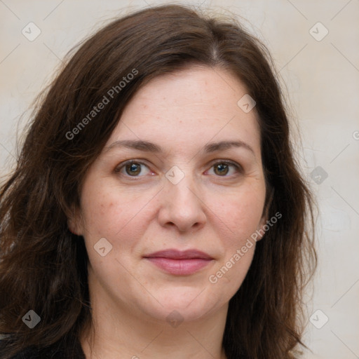 Joyful white adult female with long  brown hair and grey eyes