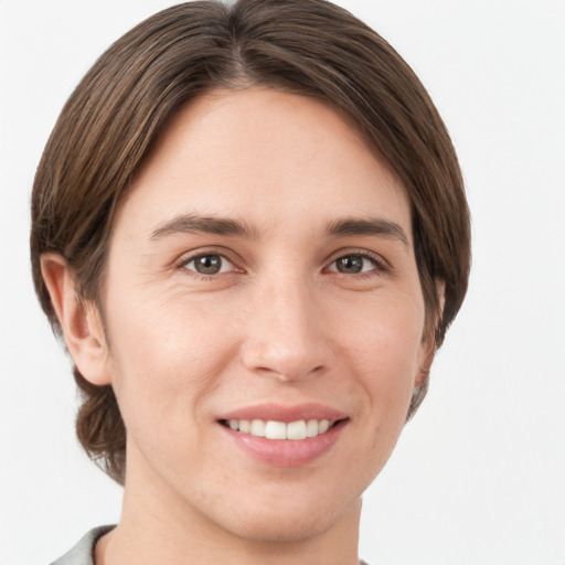 Joyful white young-adult female with short  brown hair and grey eyes