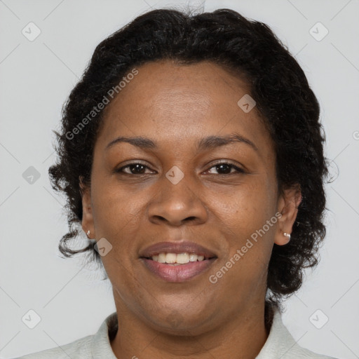 Joyful black adult female with short  brown hair and brown eyes