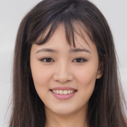 Joyful asian young-adult female with long  brown hair and brown eyes