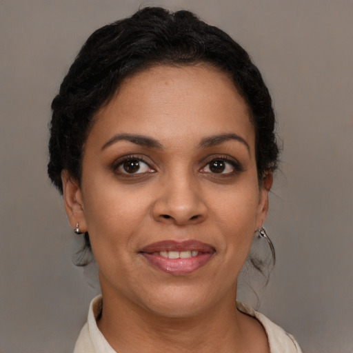 Joyful latino young-adult female with short  brown hair and brown eyes
