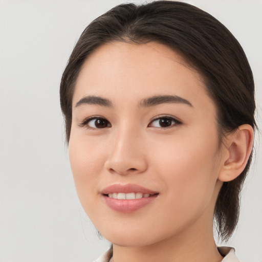 Joyful white young-adult female with medium  brown hair and brown eyes