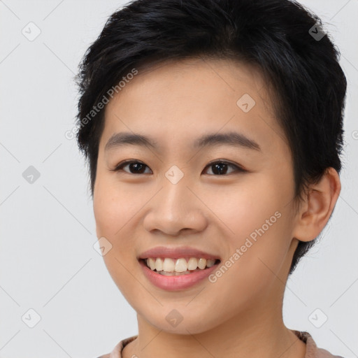 Joyful asian young-adult female with short  brown hair and brown eyes