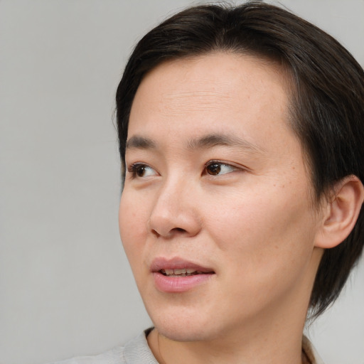 Joyful asian young-adult male with medium  brown hair and brown eyes