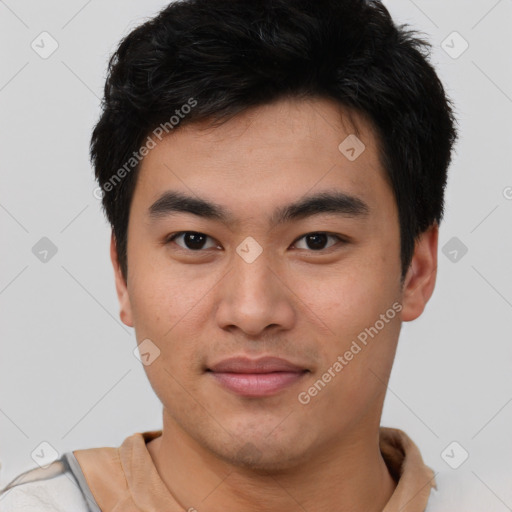 Joyful asian young-adult male with short  brown hair and brown eyes