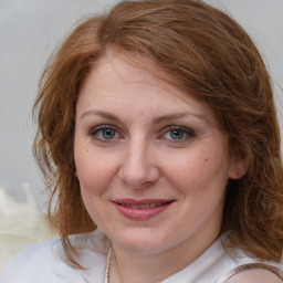 Joyful white young-adult female with medium  brown hair and blue eyes