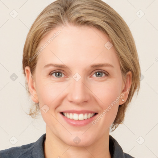 Joyful white young-adult female with medium  brown hair and blue eyes