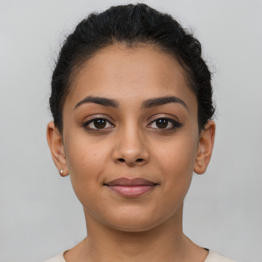 Joyful latino young-adult female with short  brown hair and brown eyes