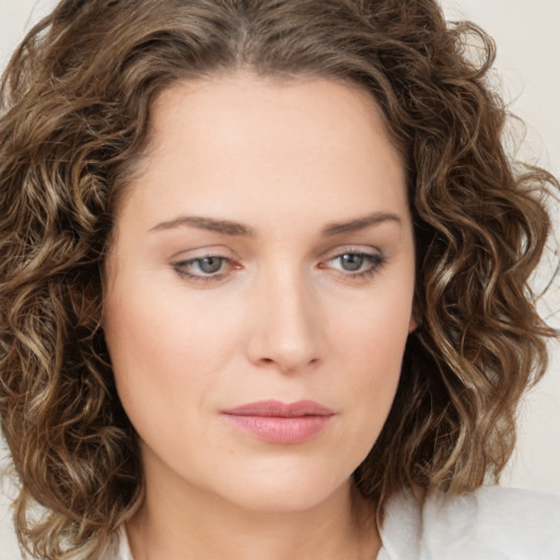 Joyful white young-adult female with medium  brown hair and green eyes