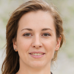 Joyful white young-adult female with medium  brown hair and blue eyes