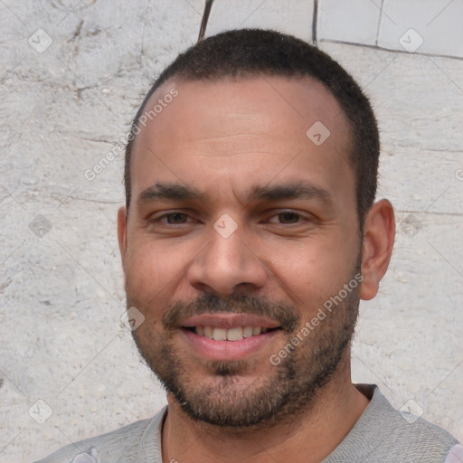 Joyful white young-adult male with short  black hair and brown eyes