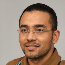 Joyful latino adult male with short  black hair and brown eyes