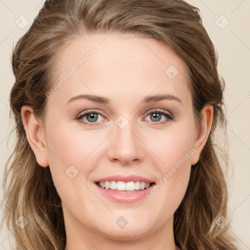 Joyful white young-adult female with long  brown hair and green eyes