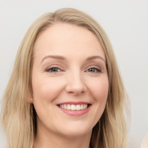 Joyful white young-adult female with long  brown hair and blue eyes