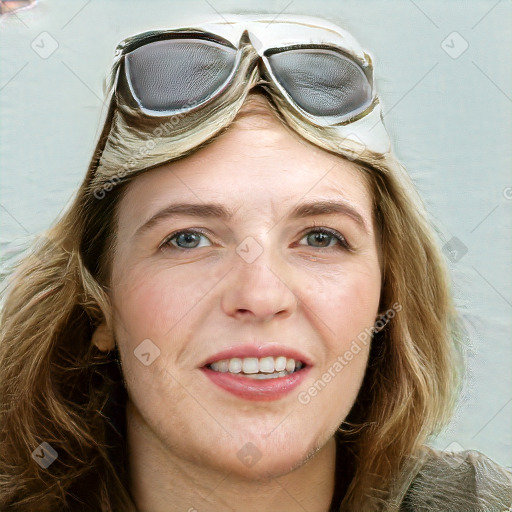 Joyful white young-adult female with long  brown hair and blue eyes