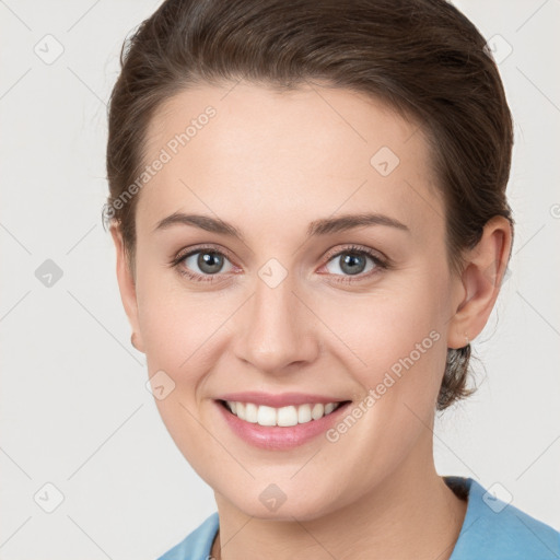 Joyful white young-adult female with short  brown hair and grey eyes