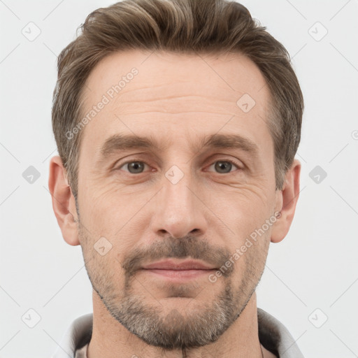 Joyful white adult male with short  brown hair and grey eyes