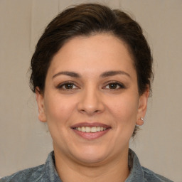 Joyful white adult female with medium  brown hair and brown eyes