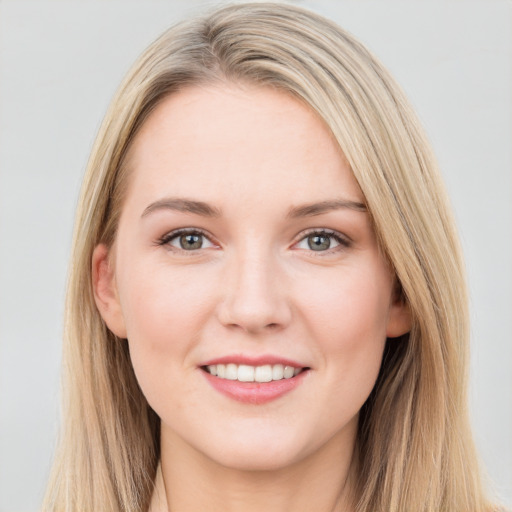 Joyful white young-adult female with long  brown hair and blue eyes